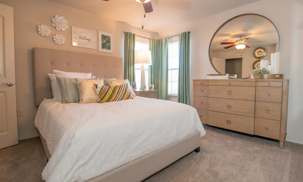 Cozy master bedroom with ceiling fan at Portico at Friars Creek Apartments in Temple, Texas