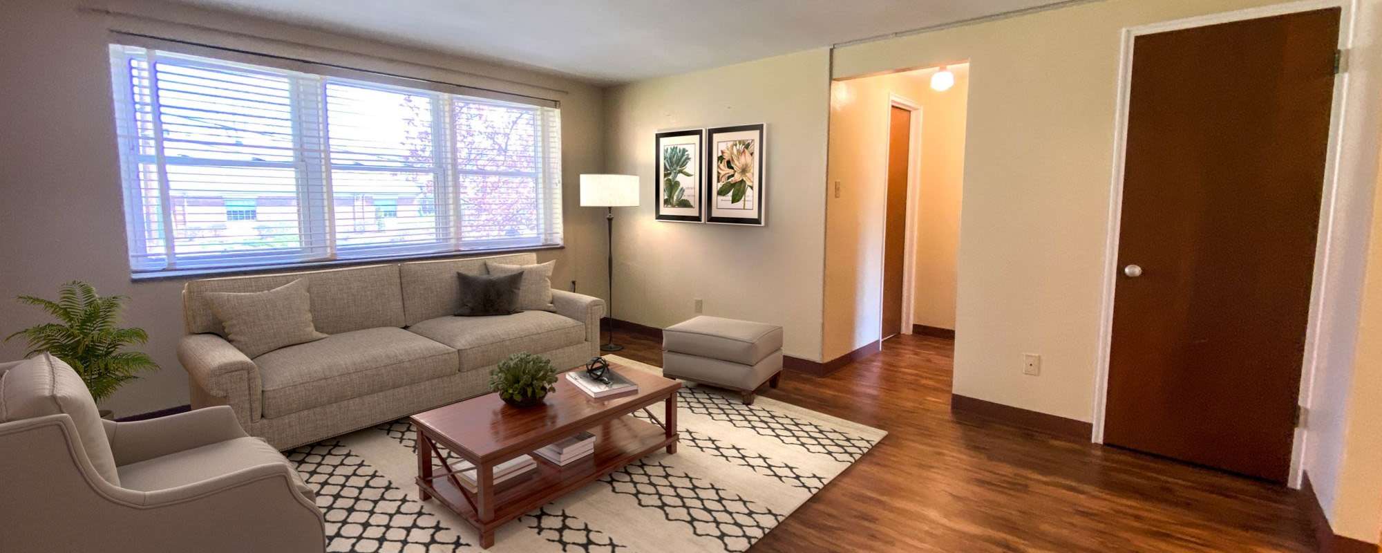 Spacious living room with couch, chair and coffee table at Lebanon Vue in Pittsburgh, Pennsylvania