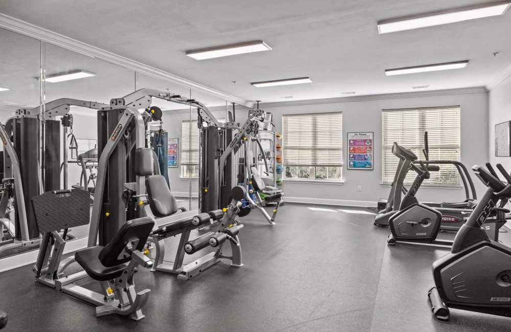 Bright fitness center with various exercise machines and equipment at Magnolia Heights in Charlotte, North Carolina