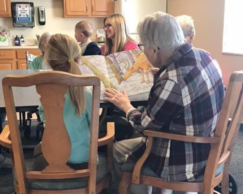 Resident Lois having story time with preschool children for her dare to dream event from Lawton Senior Living in Lawton, Iowa.