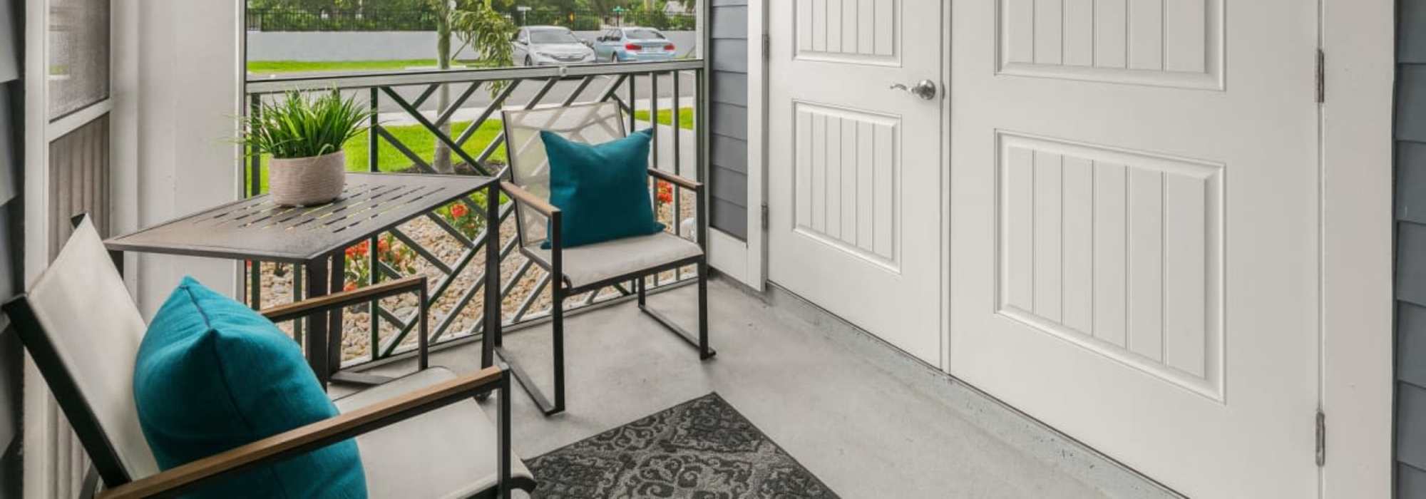 Cozy seating area in the balcony at The Bergamot Apartments On 780 in Sarasota, Florida