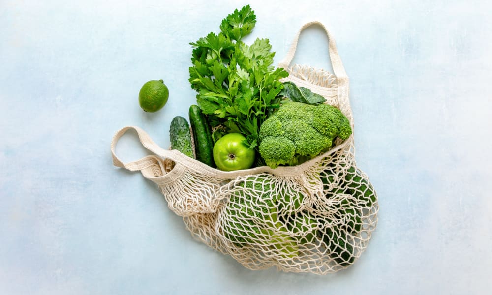 Reusable produce bag fulled with fresh vegetables at Two Twelve Clayton in Clayton, Missouri