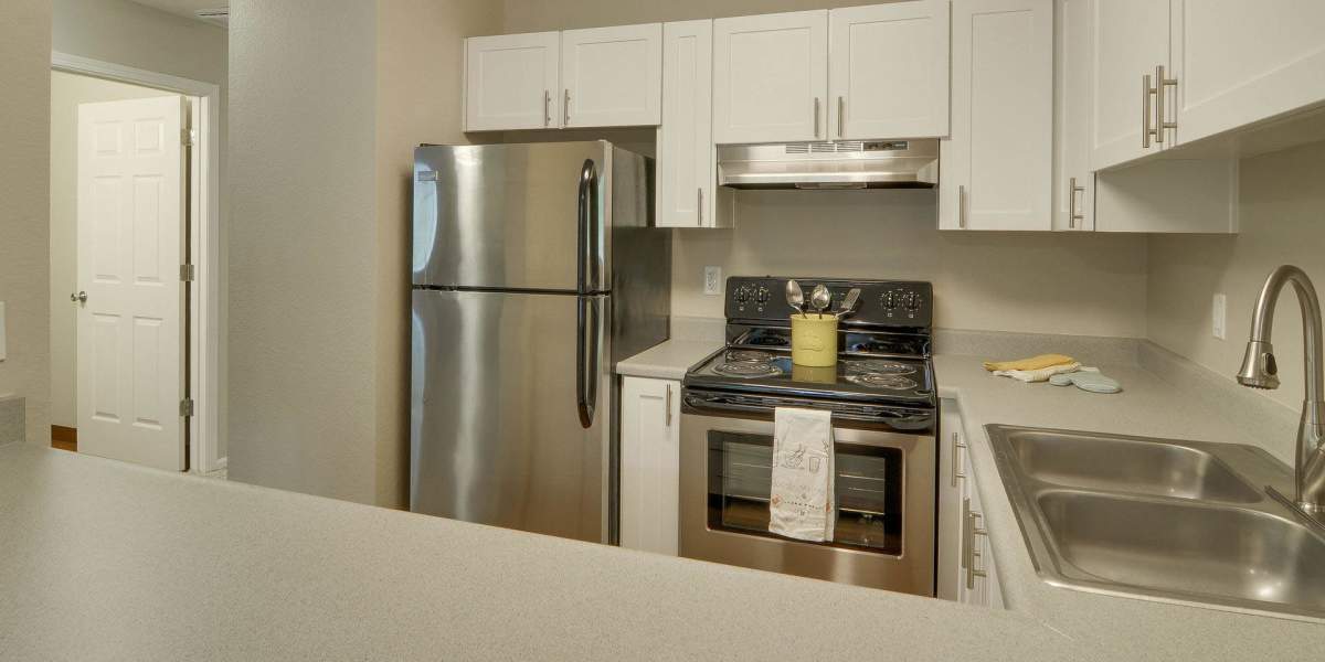 Renovated kitchen with cabinets and counter tops at Carriage House Apartments in Vancouver, Washington