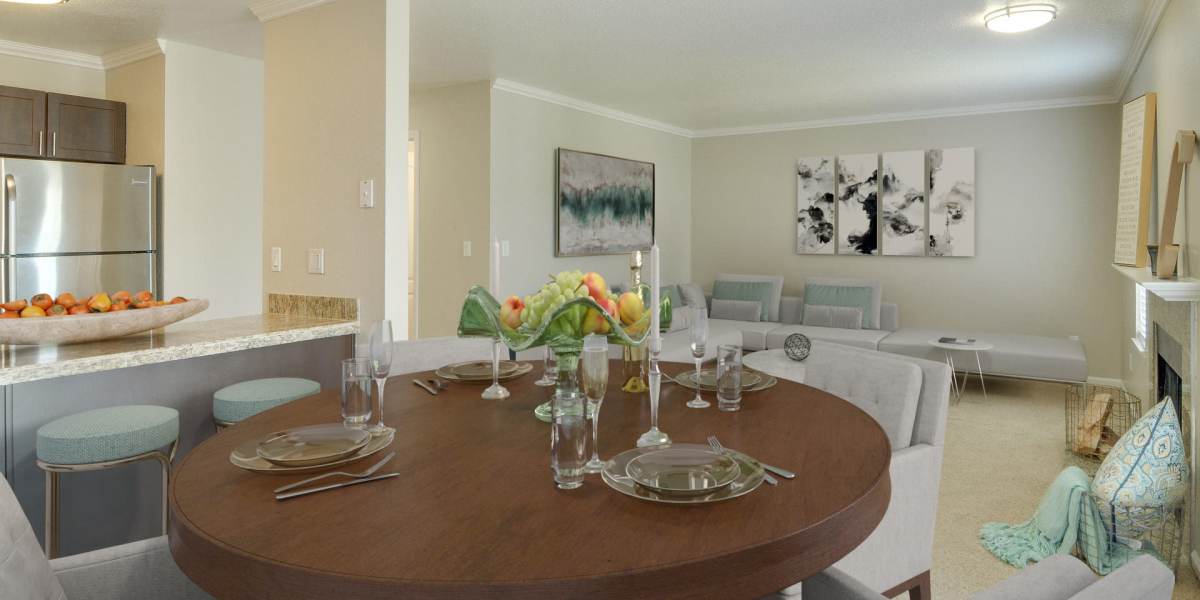 Dining room looking into the kitchen and living room at Carriage House Apartments in Vancouver, Washington