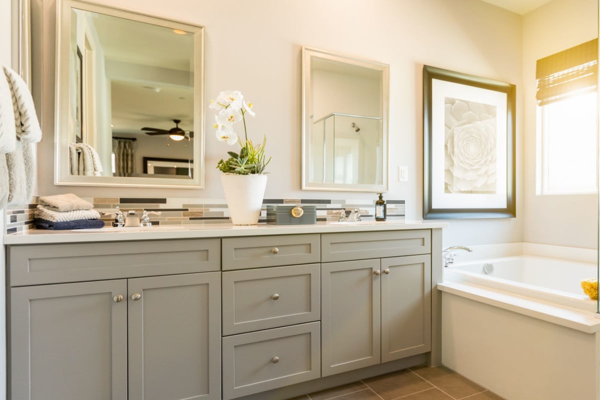 Bathroom with tiled flooring and a granite countertop in a model apartment home at The Pointe at Siena Ridge in Davenport, Florida