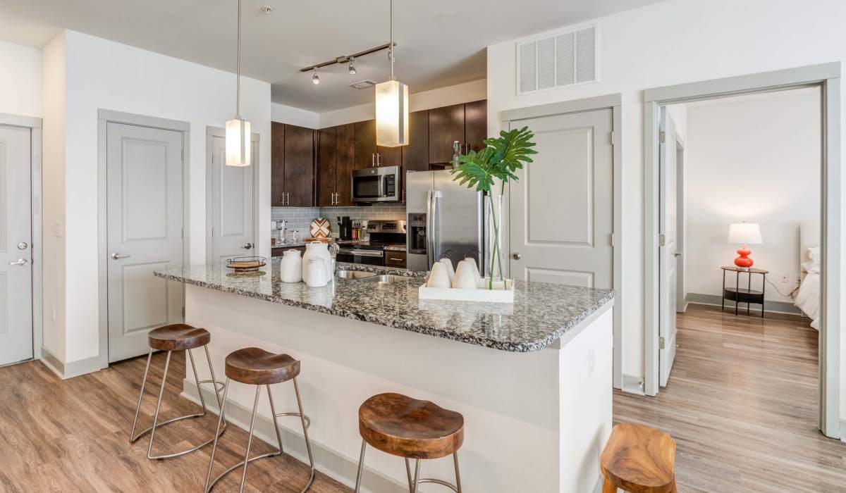 Kitchen with designer granite countertop and chairs at The Carillon in Nashville, Tennessee