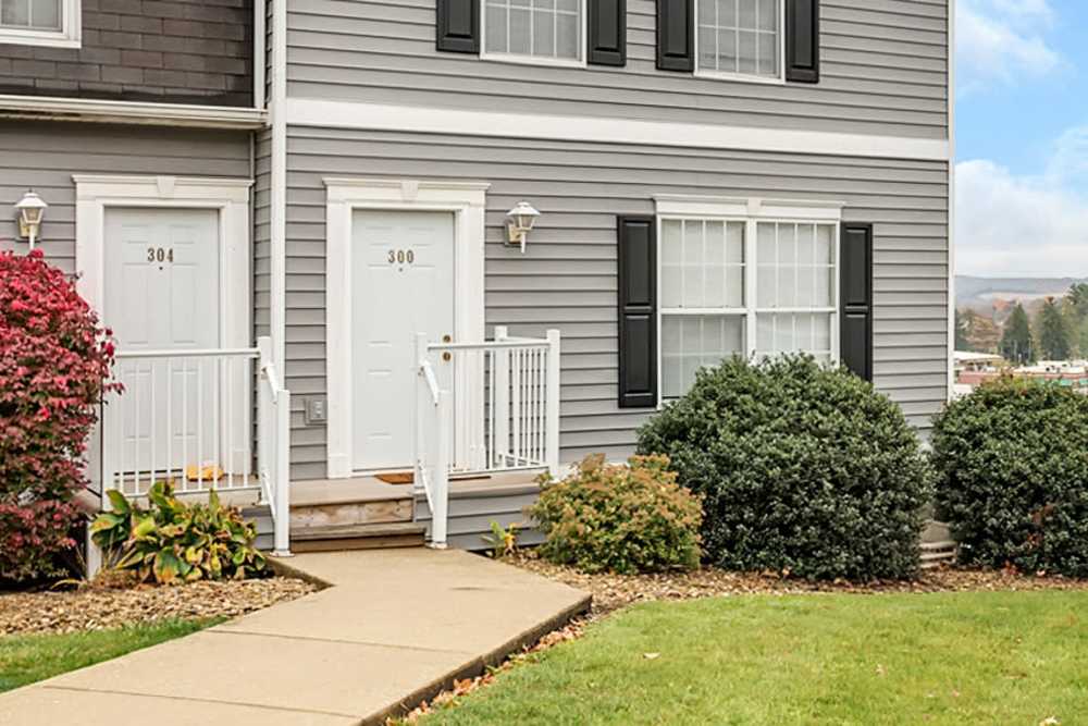 Entrance of apartment with lush greenery at Traverse Commons in Indiana, Pennsylvania
