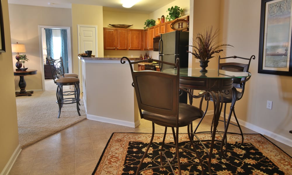 Dining room area and view of the kitchen at The Heights at McArthur Park in Fayetteville, North Carolina