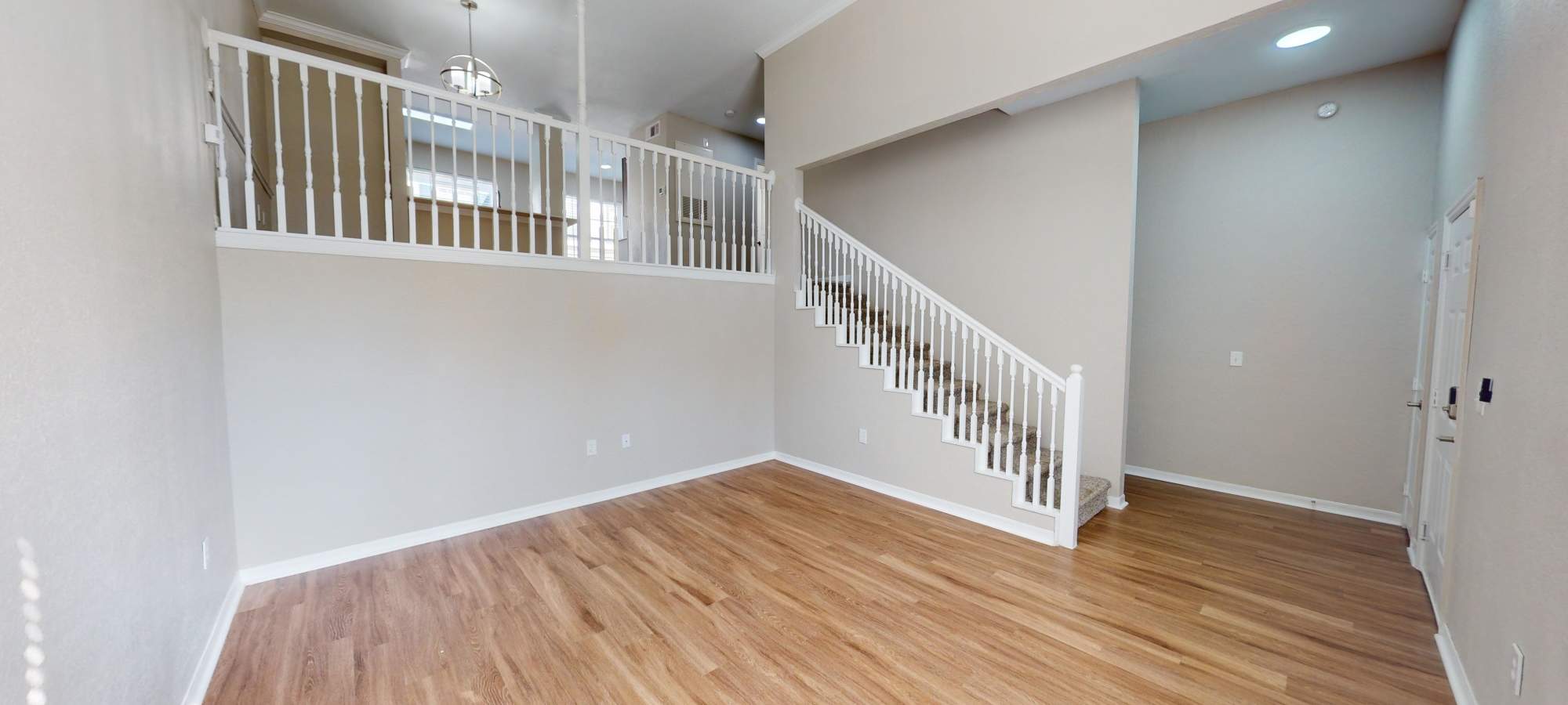 Living room with upstairs loft at Harbortown Apartments in Orlando, FL