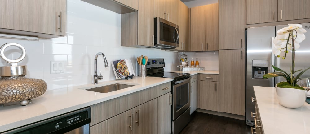 Beautiful, tan kitchen cabinetry at Strata Apartments in Denver, Colorado
