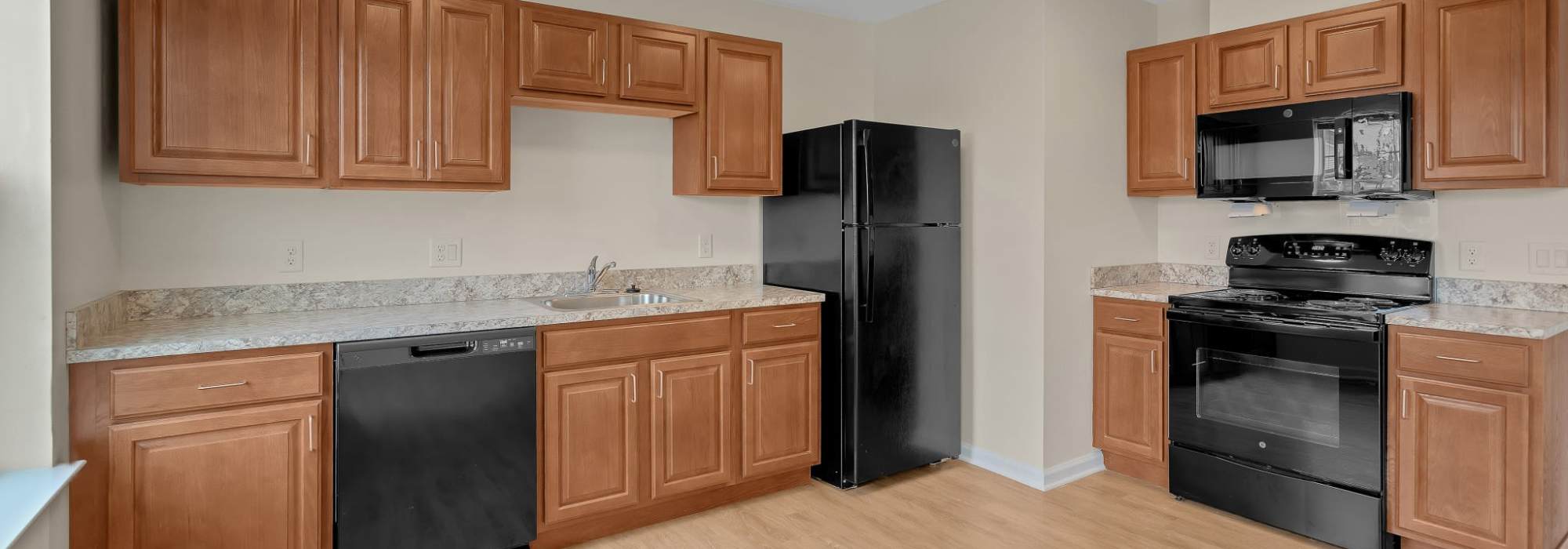 Kitchen with black appliances at Robinson Overlook in Columbia, Maryland
