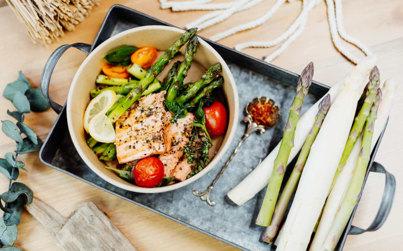 Hearty meal of grilled salmon over a bed of greens at a The Blake community