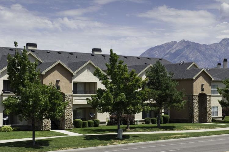 Exterior view with mountains at Alpine Meadows Apartments in Sandy, Utah