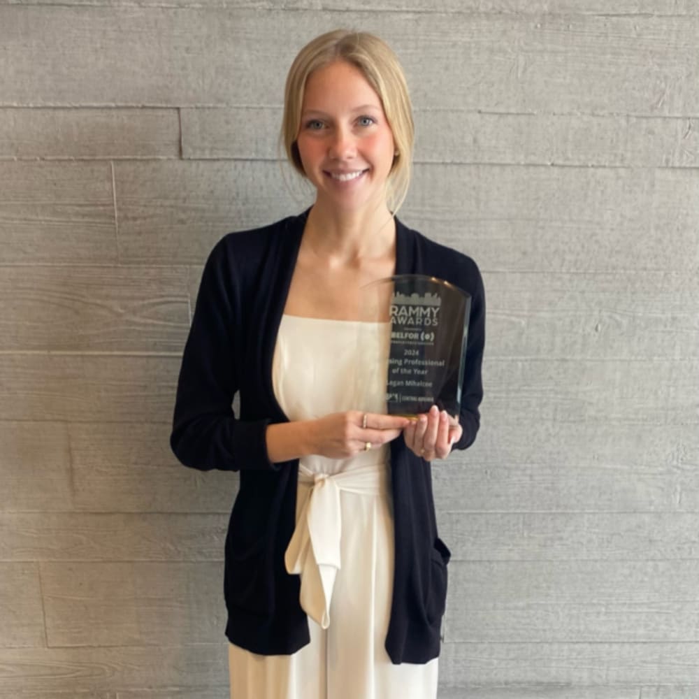 Employee holding an award at Drucker + Falk in Newport News, Virginia