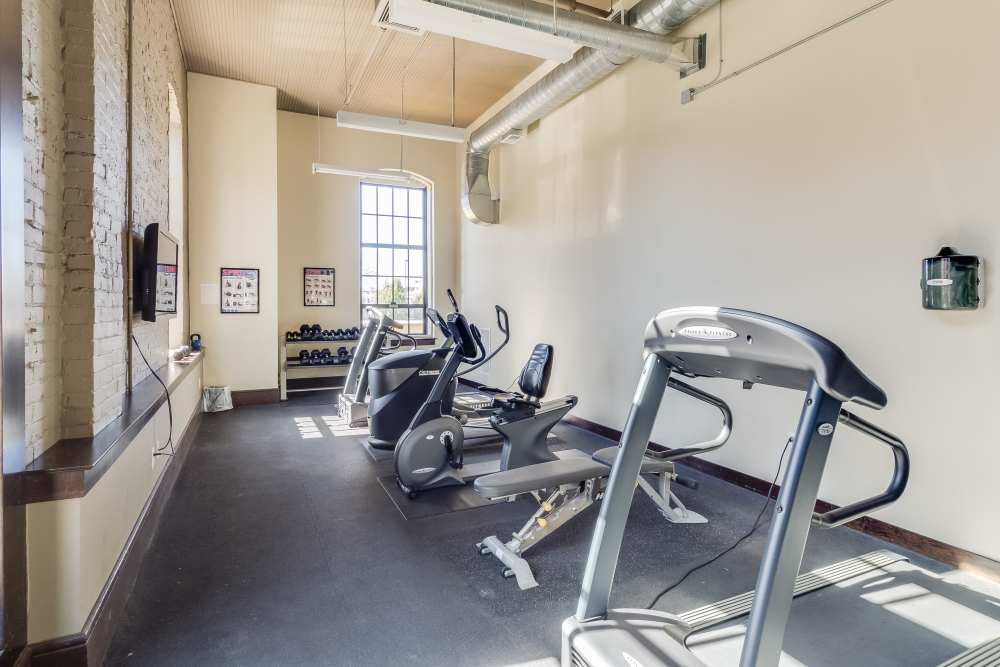 Exercise equipment with large window at Rumely Lofts in Des Moines, Iowa