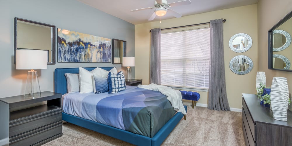 Bedroom with ceiling fan at One Rocky Ridge Apartment Homes in Douglasville, Georgia