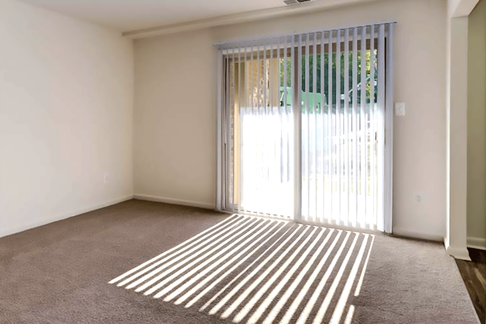 Door to patio with sunlight streaming in at Hallfield Apartments in Perry Hall, Maryland