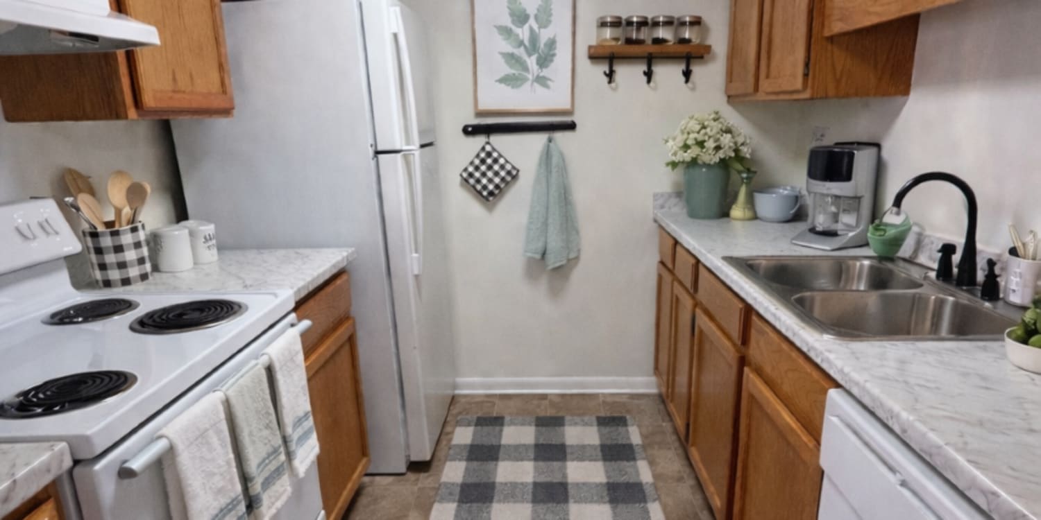 Kitchen with wooden cabinets at Lexington Place Apartments in West Columbia,South Carolina