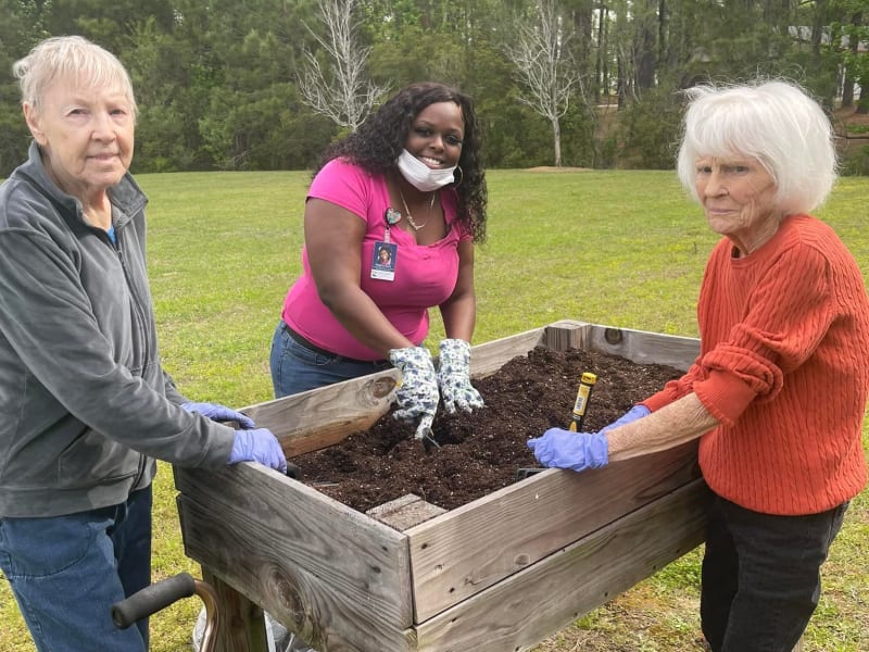Residents gardening outside at Carolina Gardens at Conway in Conway, South Carolina