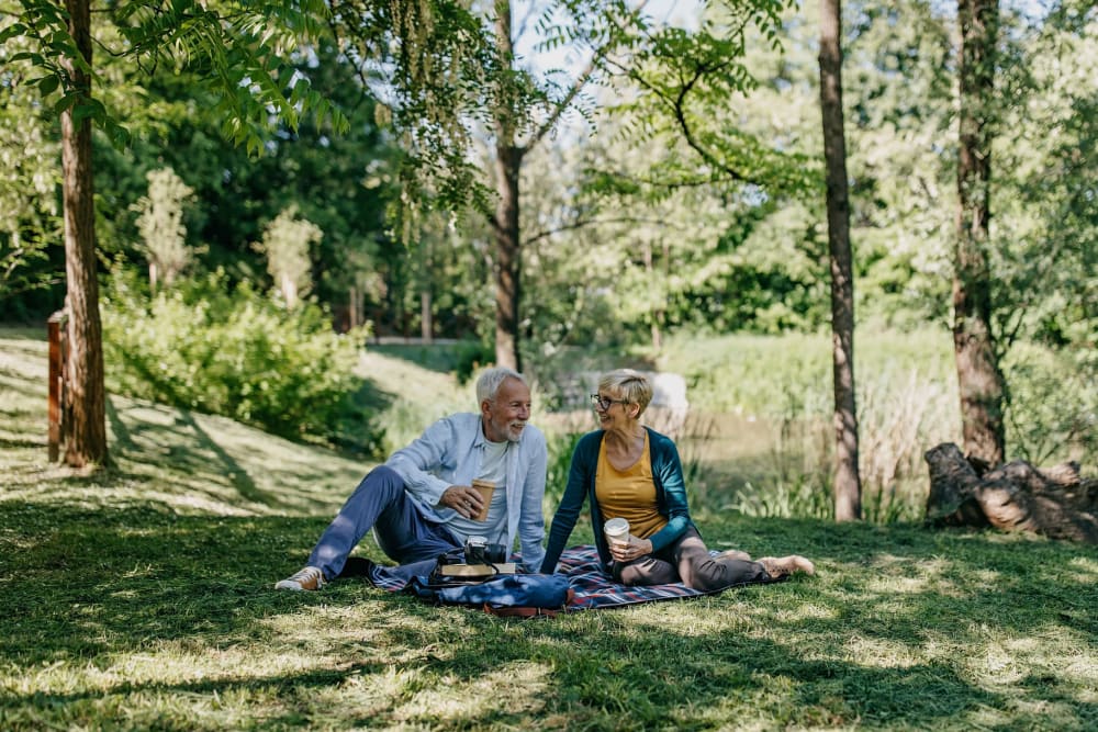 Resident couple habing a picnic at Carriage Inn Bryan in Bryan, Texas