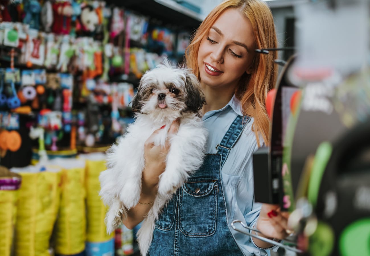 Resident shopping with her dog at a pet store near Apartments at Sanatoga Greene, Sanatoga, Pennsylvania