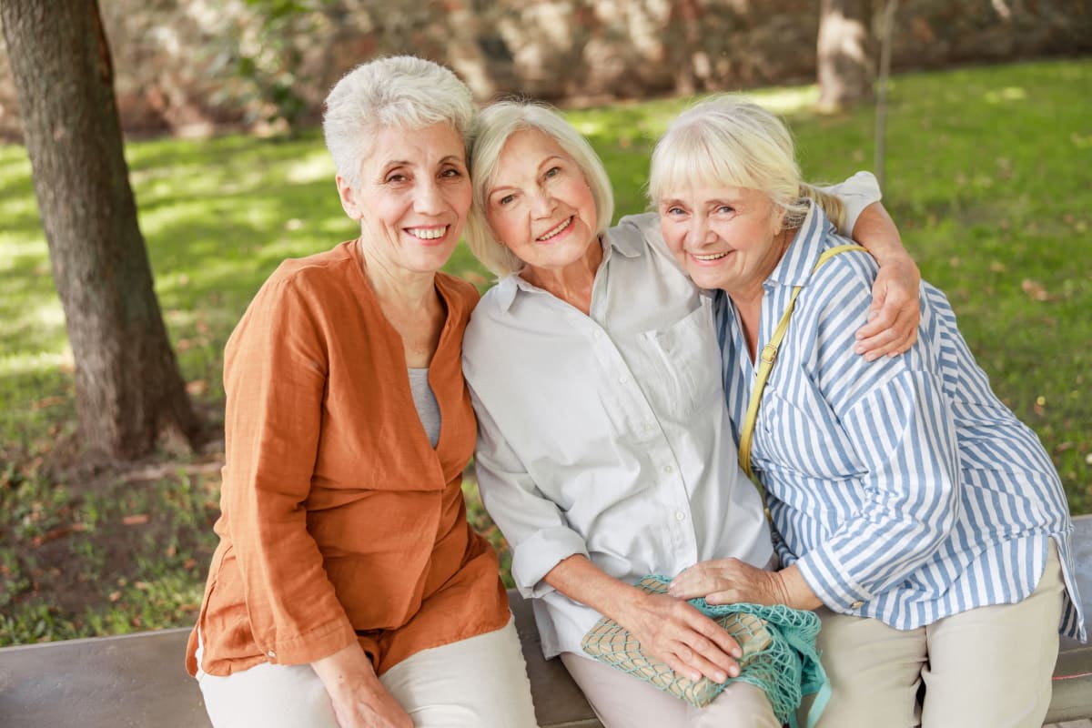 Three friends sitting on a bench at FountainBrook in Midwest City, Oklahoma