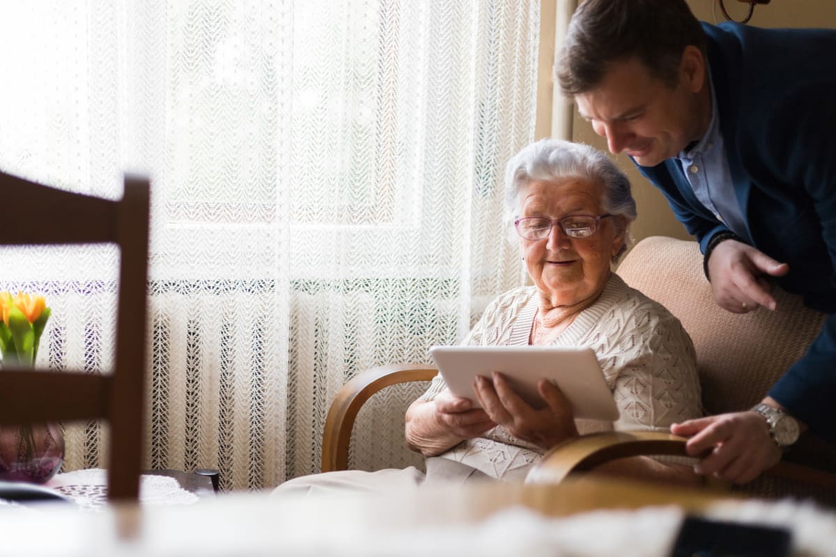 Son and mother looking at a tablet at Creekside Village in Ponca City, Oklahoma