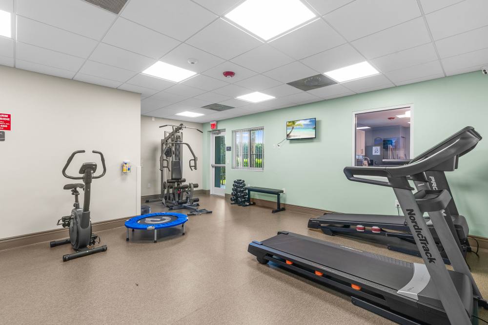 Fitness center equipped with treadmills at Sunset Bay Apartments in Cutler Bay, Florida