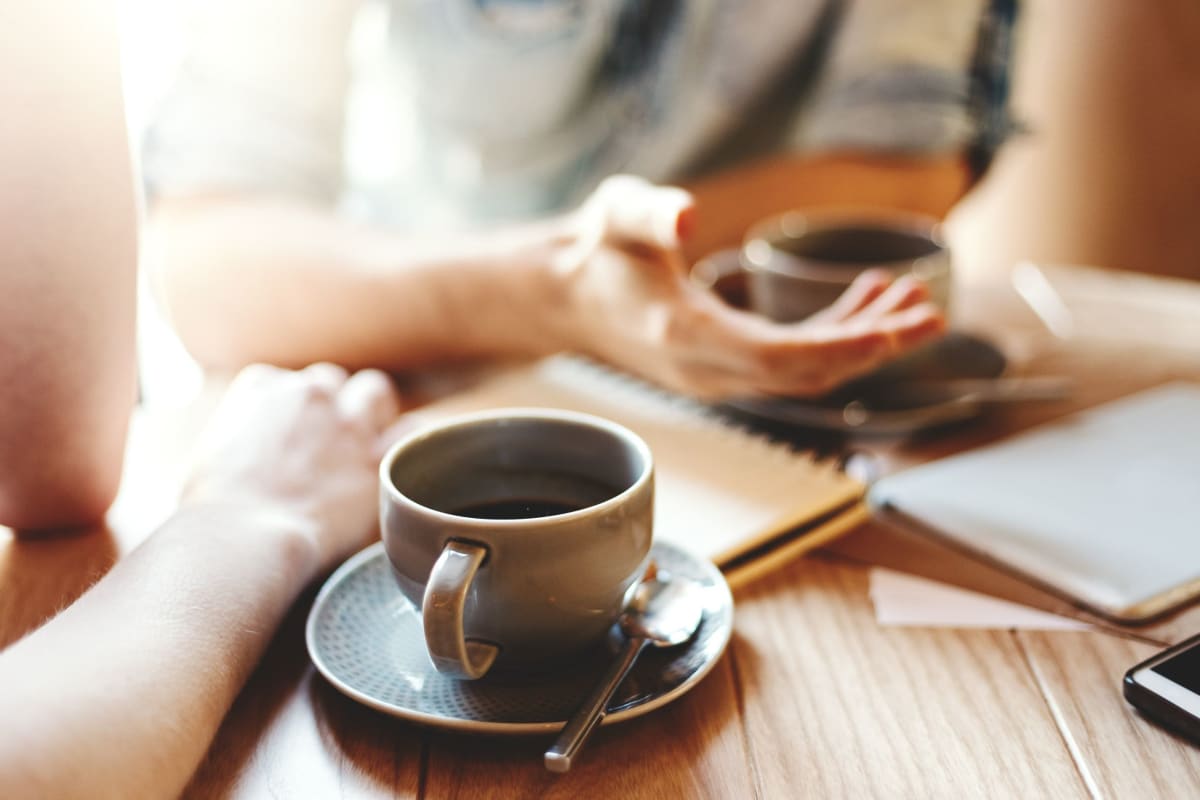 Friends enjoying coffee at a retail area developed by Decron Properties, Los Angeles, California