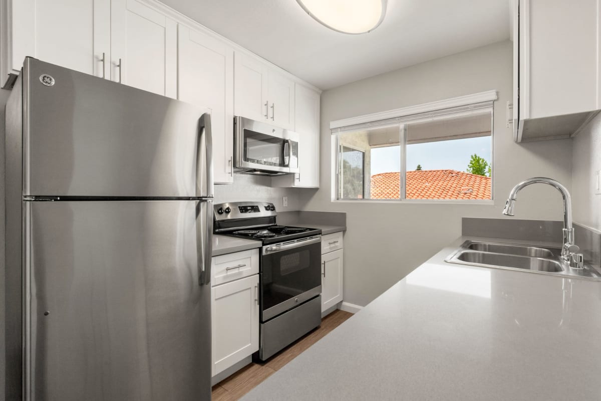 Kitchen with stainless-steel appliances at Los Robles Apartments, Thousand Oaks, California