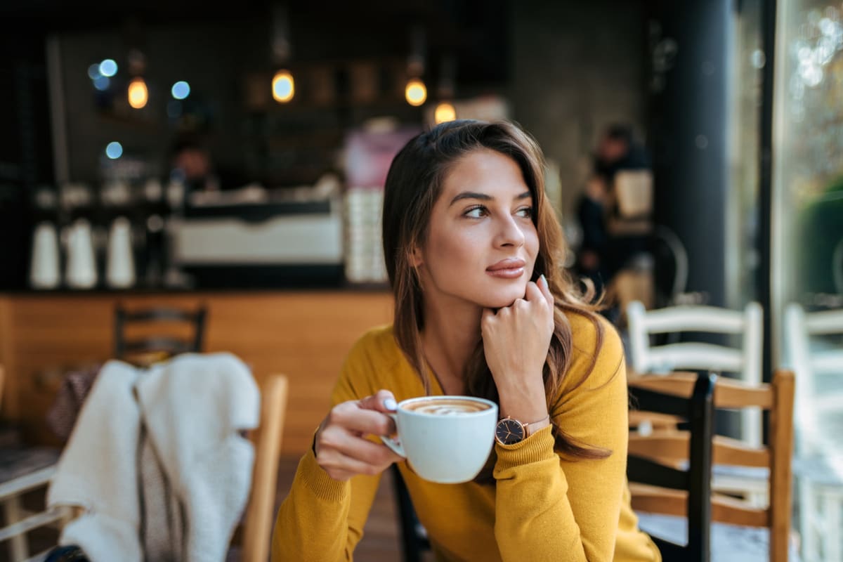 Resident having coffee at local coffee shop in Kingwood, Texas from Marquis at Kingwood