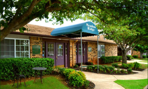 front entrance and lush landscaped grounds at Meadow Ridge in Midwest City, Oklahoma