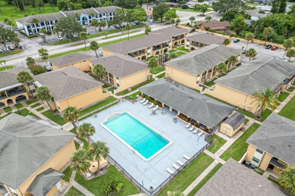 Aerial view of community swimming pool with lounge chairs at San Jose in Winter Park, Florida