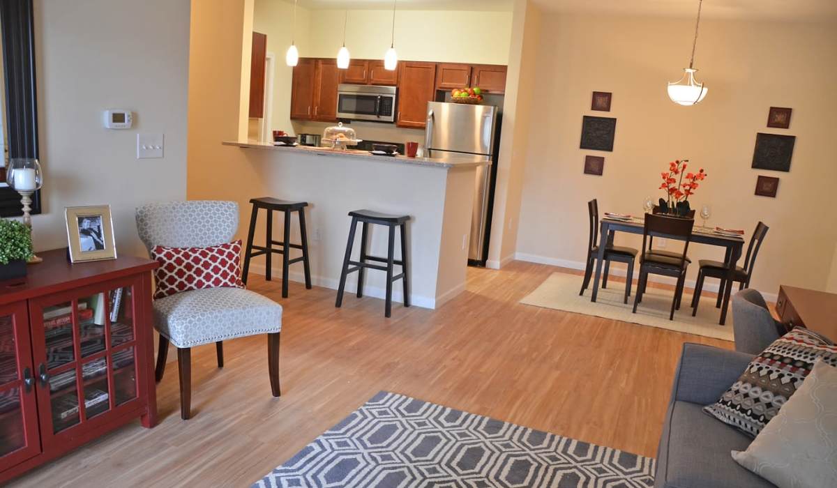 Living area with access to kitchen at The Enclave Apartments in Columbus. IN