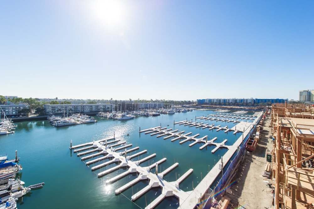 Luxury marina with white docks and boats at Capri Apartments in Marina Del Rey, California