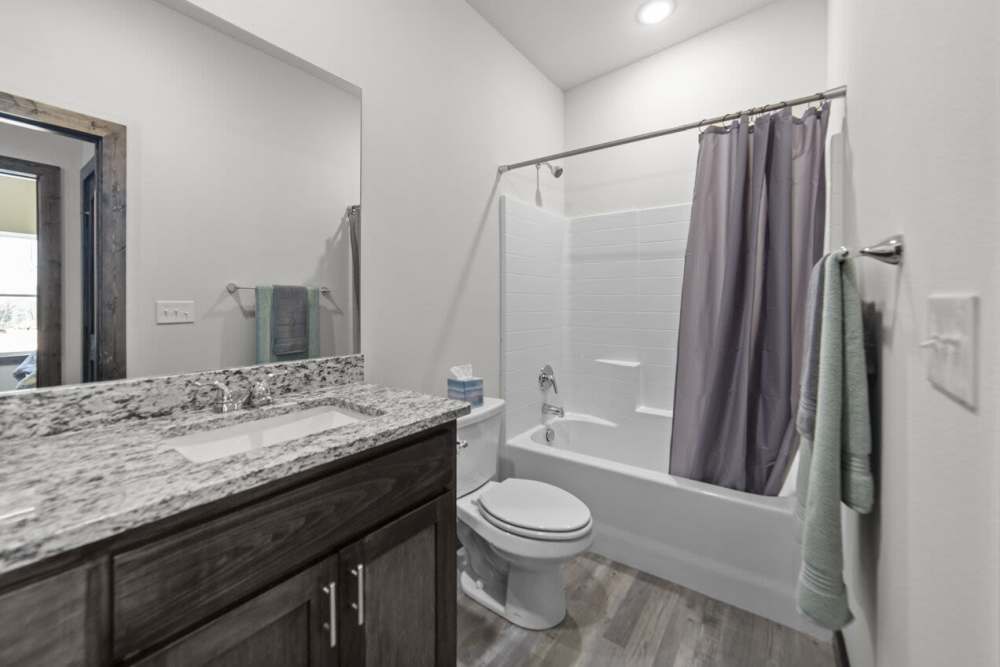 Bright bathroom at Settlers Trail Apartments in Lindale, Texas