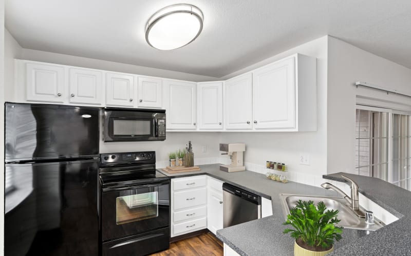 Kitchen with White Renovate Cabinetry at Autumn Chase Apartments in Vancouver,