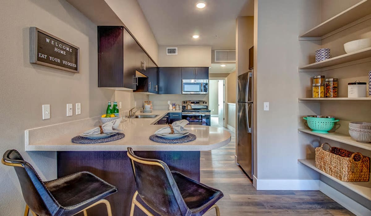 Kitchen with island and wood cabinetry at Riverside Park Apartments in Reno, Nevada