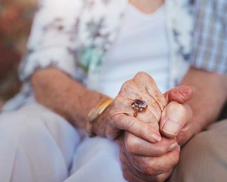 Couple holding hands at Arcadia Senior Living Pace in Pace, Florida