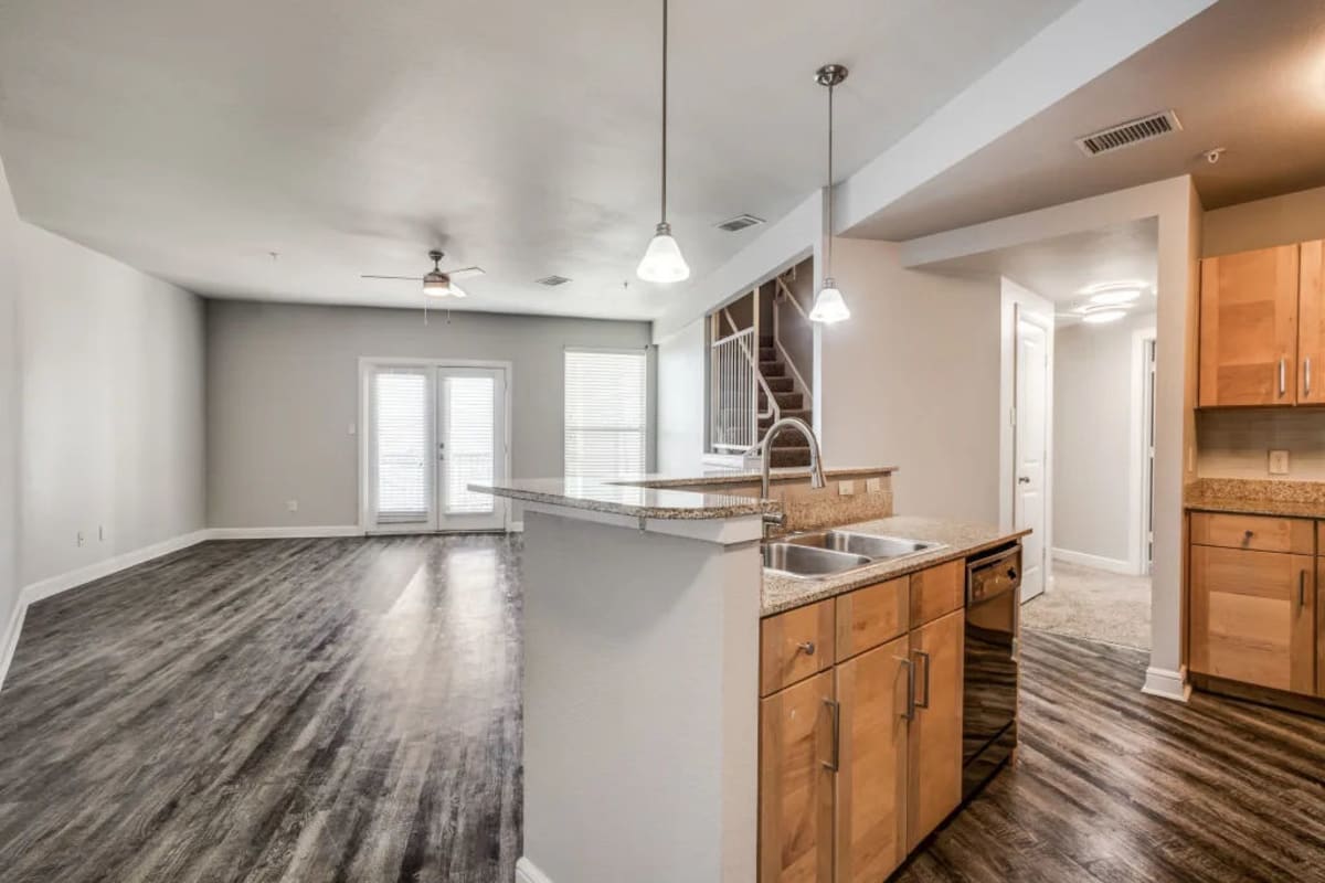 An apartment with a kitchen island at Square9 in Denton, Texas