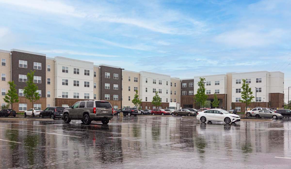 Wide exterior view of the apartment building at The Enclave on Main in Whitehall, Ohio