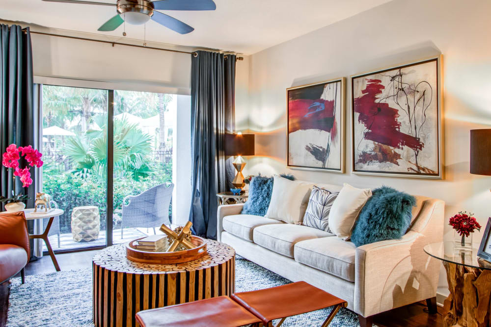 Model living room opening onto a private balcony at Luzano in Pompano Beach, Florida