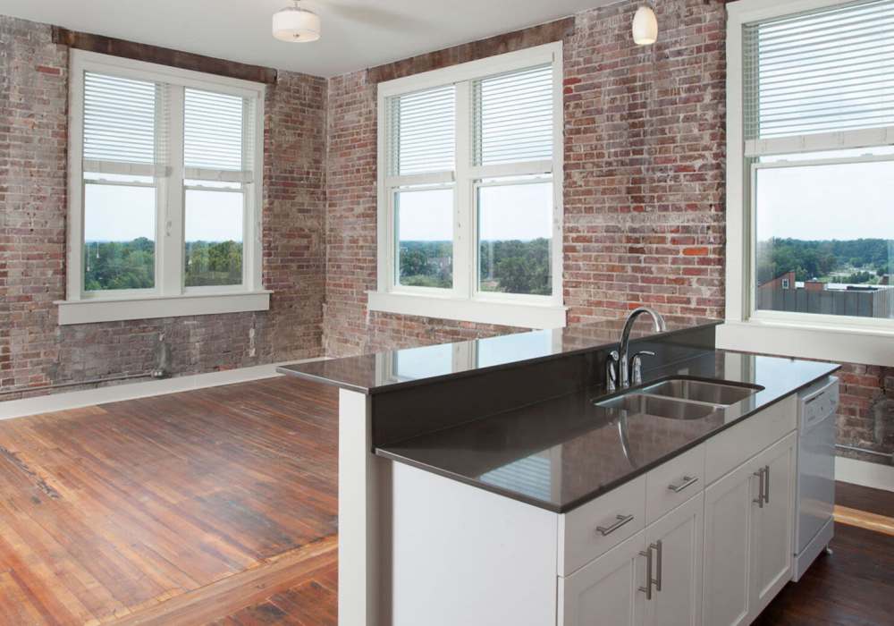 Kitchen island with sink and countertop at Hub City Lofts in Hattiesburg, Mississippi
