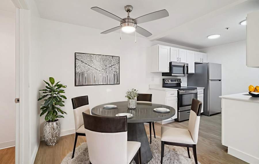 Dining room with ceiling fan and view of kitchen at Foundry on Fifth in Renton, Washington