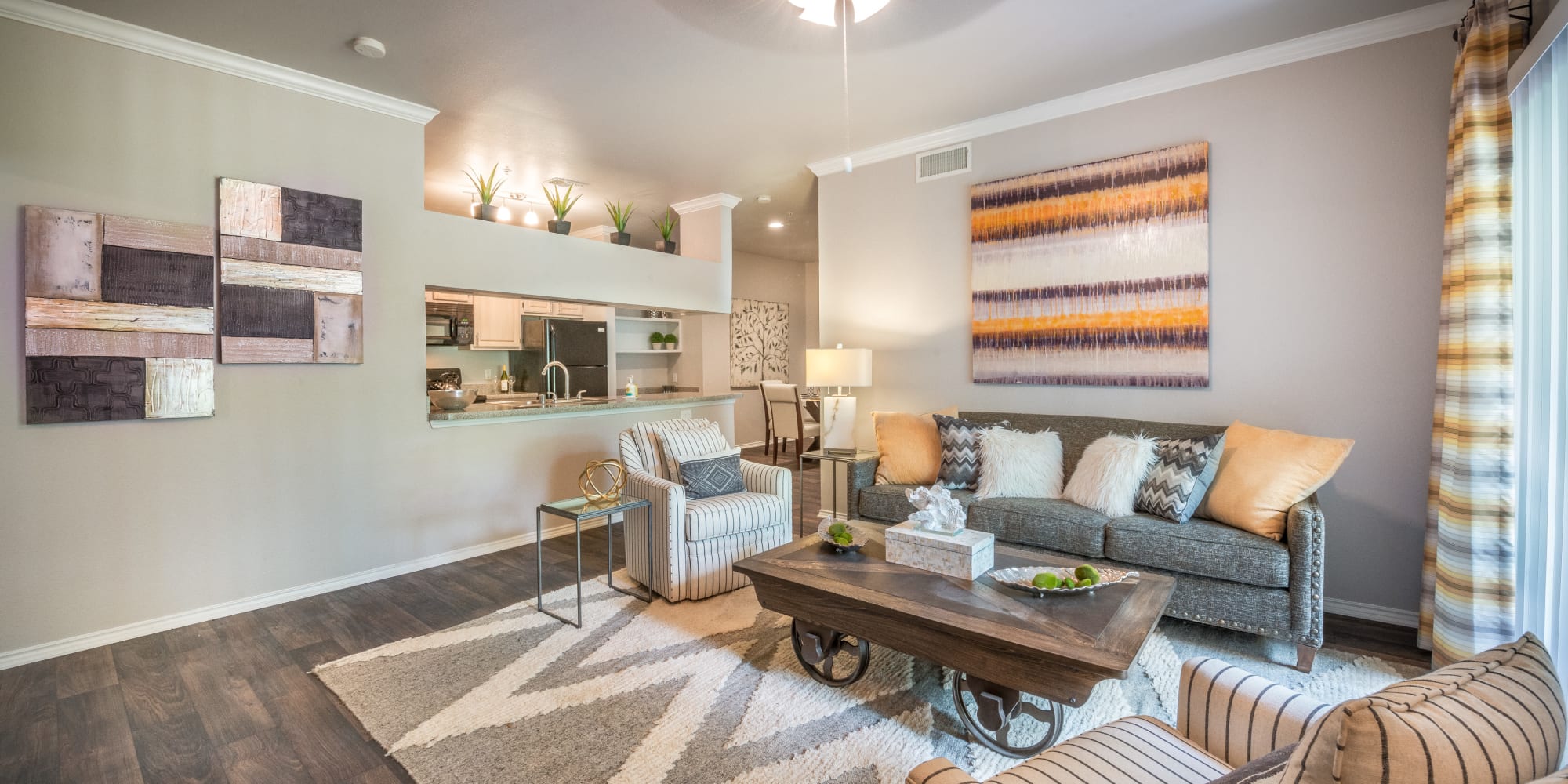 Well-furnished living area with hardwood floors in a model home at 23Hundred @ Ridgeview in Plano, Texas