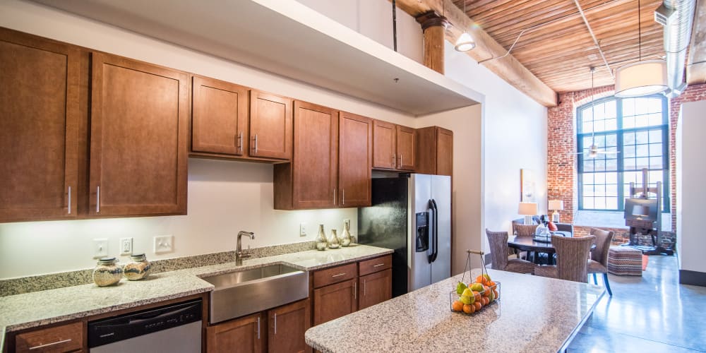 Cozy bedroom with large windows at Loray Mill Lofts in Gastonia, North Carolina
