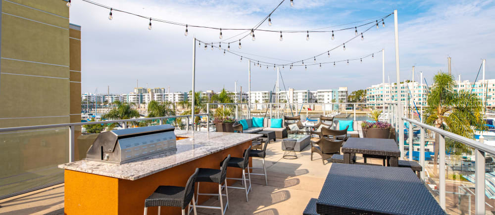 A barbecue and seating on the sundeck at Harborside Marina Bay Apartments in Marina del Rey, California