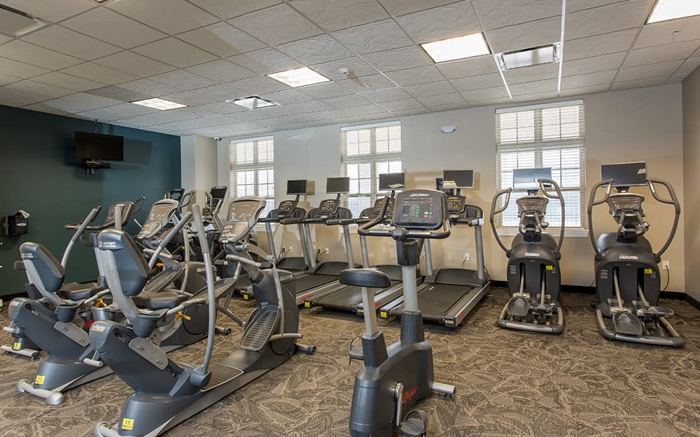 Well-equipped fitness center with cardio equipment at Gateway Landing on the Canal in Rochester, New York