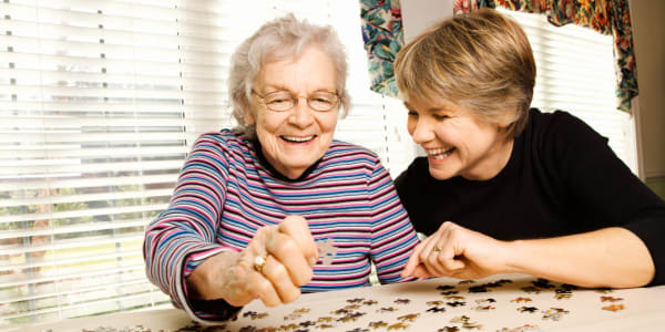 Resident and daughter solving a puzzle together at Edgerton Care Center in Edgerton, Wisconsin