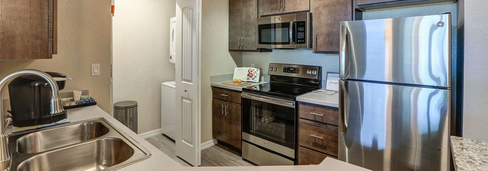 Sleek modern kitchen with stainless steel appliances and stylish cabinetry at Lemon Bay Apartments in Englewood, Florida.
